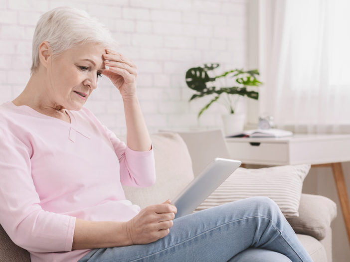 woman reading confusing Medicare acronyms and abbreviations